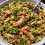 thai chicken salad with crunchy nuts tangy dressing and fresh vegetables