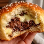 swiss brioches chocolate chip vanilla custard brioches fresh baked warm golden brown fluffy brioche buns with melted chocolate chips and creamy custard filling on a rustic wooden surface
