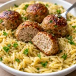 Greek chicken meatballs served with lemon flavored orzo pasta on a white plate