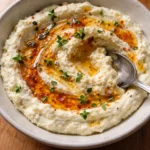 delicious ricotta dip with hot honey in a bowl ready to serve on a party table
