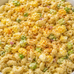 deviled egg macaroni salad served in a bowl with creamy dressing and chopped green onions on top