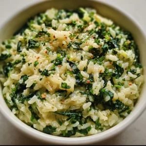 Creamy spinach rice dish served with fresh herbs