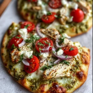 Pesto chicken flatbread topped with mozzarella and fresh basil on a wooden board